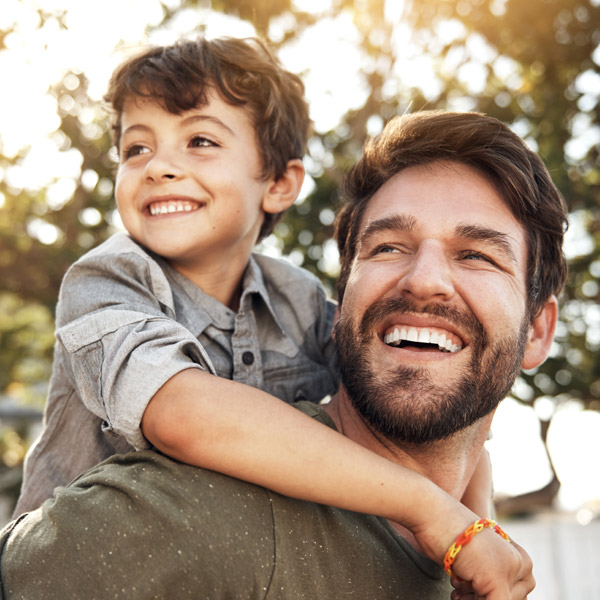 father and son smiling together